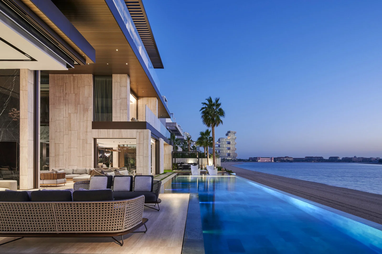 Villa fit out in Dubai featuring a waterfront pool, outdoor lounge and contemporary exterior finishes